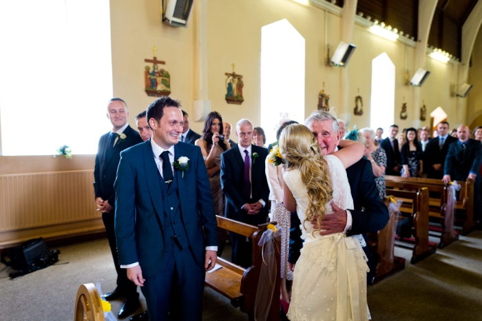 bride hugging father wedding ceremony